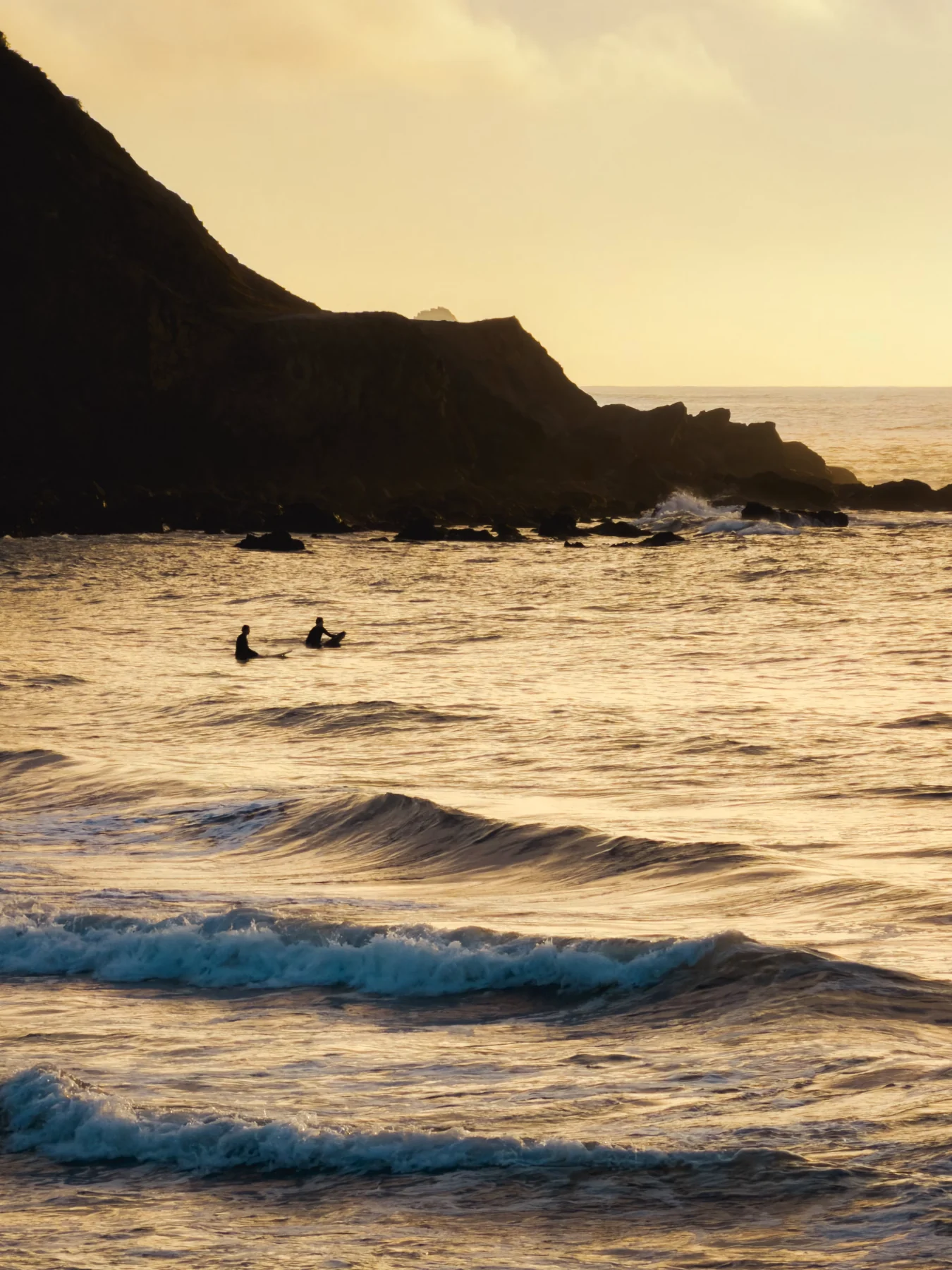 Original source photograph of surfers in evening light